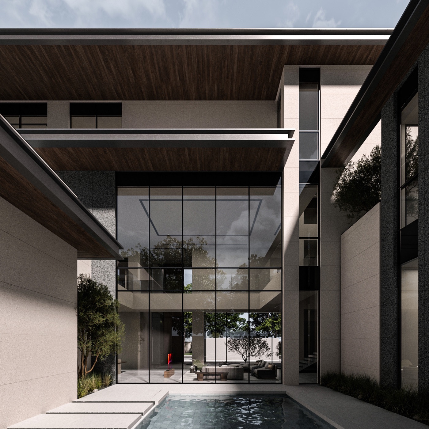 Double-height glazed living space opening onto a pool